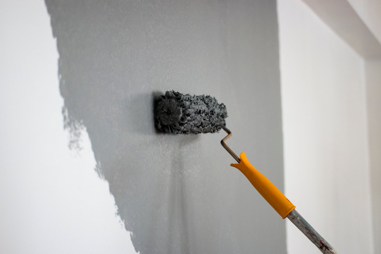 Man painting interior of home