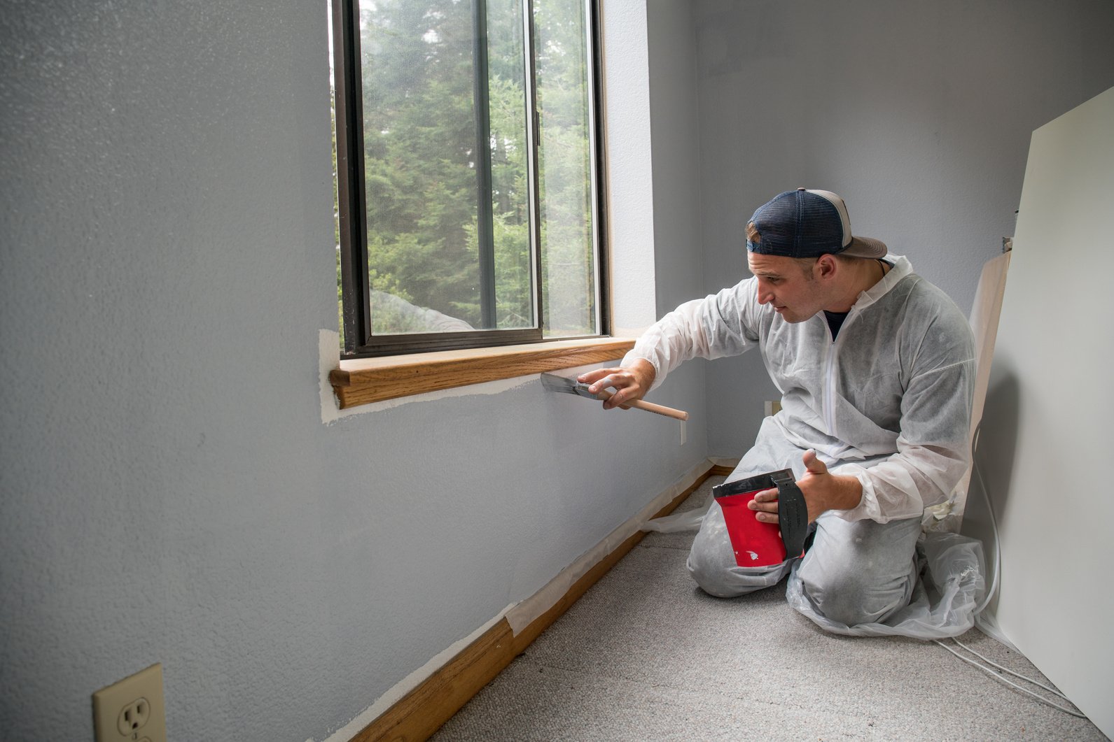 Man painting interior of home